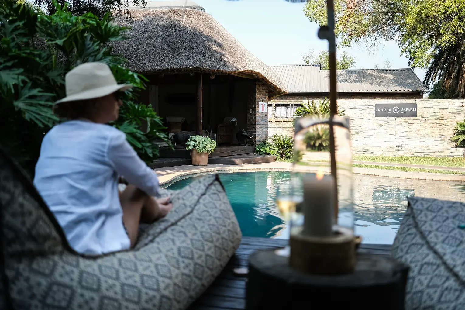 A guest relaxing beside the lodge swimming pool