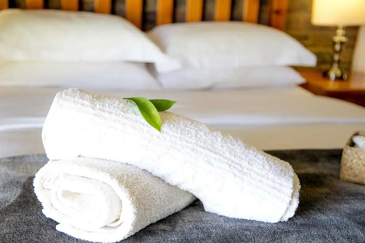 a pair of white towels on a bed